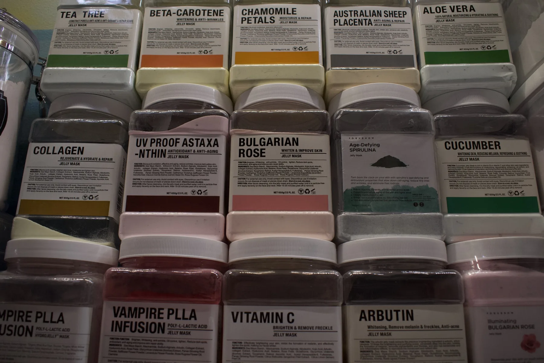 Shelves of ESSpa jelly mask jars labeled Collagen, Bulgarian Rose, Vitamin C, Aloe Vera, Chamomile Petals and more